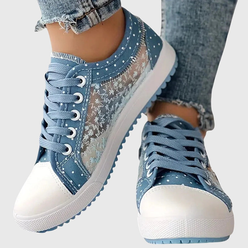 A woman walking comfortably in blue cushioned orthopaedic trainers