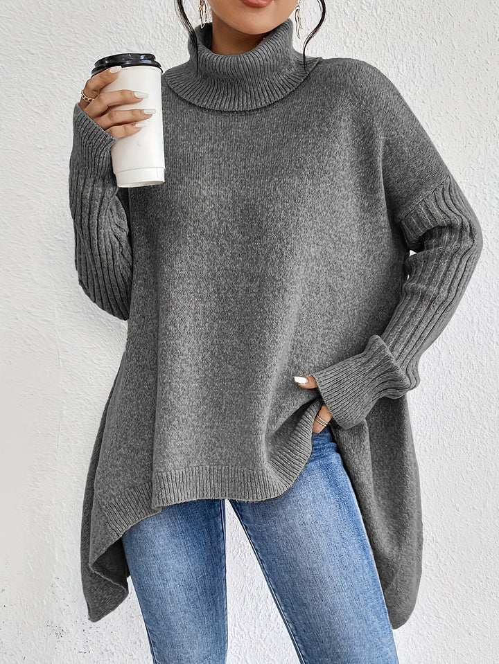 A woman wearing a stand-collar jumper with a chic asymmetric drape, warm and polished.
