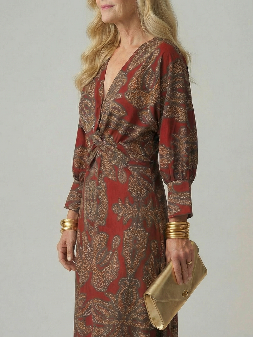 Dark green long-sleeve midi dress with diagonal wrap bodice and straight skirt in a detailed print
