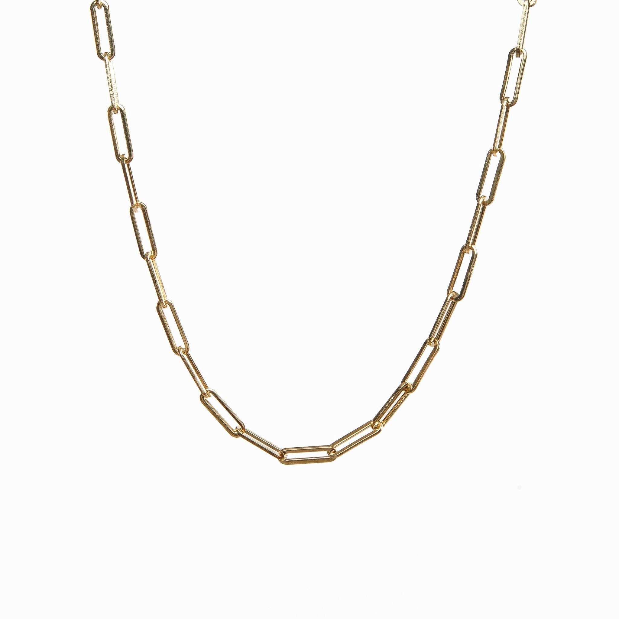 Radiant gold choker necklace laid flat on a white surface