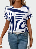 White short-sleeve blouse with bold blue geometric print and a relaxed, wide-cut silhouette