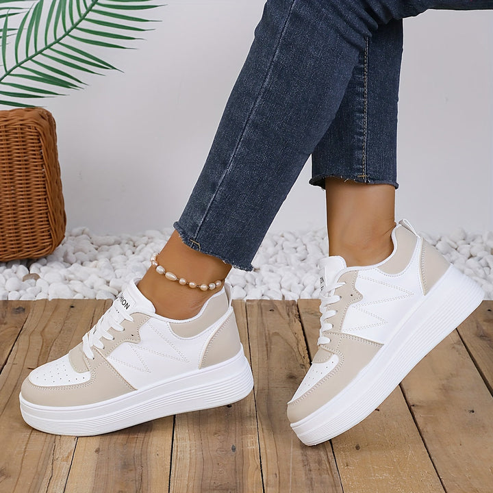 A woman wearing elegant two-tone platform trainers in the city