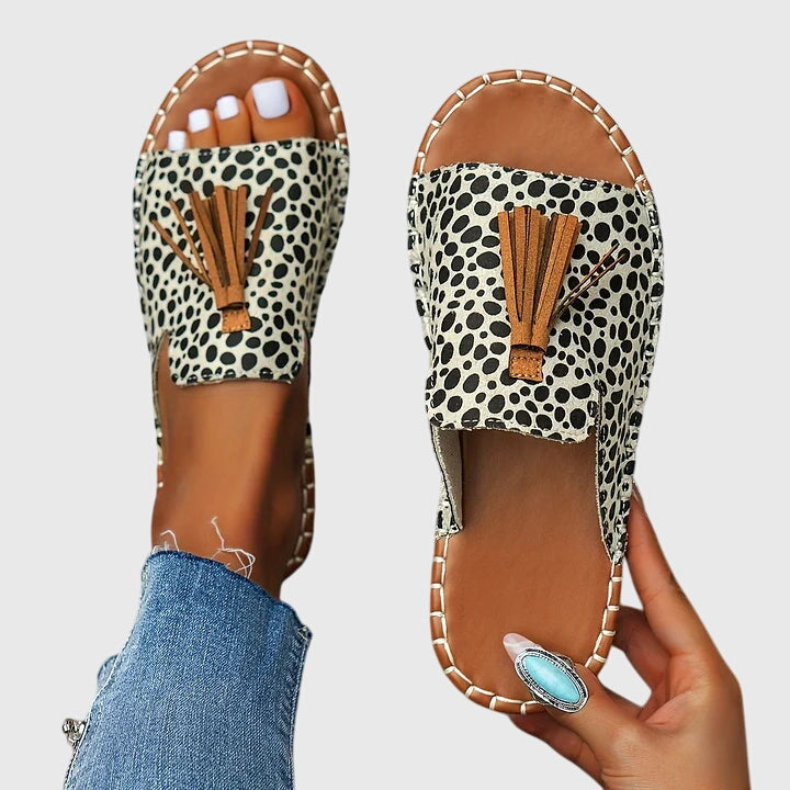 Flat boho sandals with colourful printed upper and swinging fringe detail