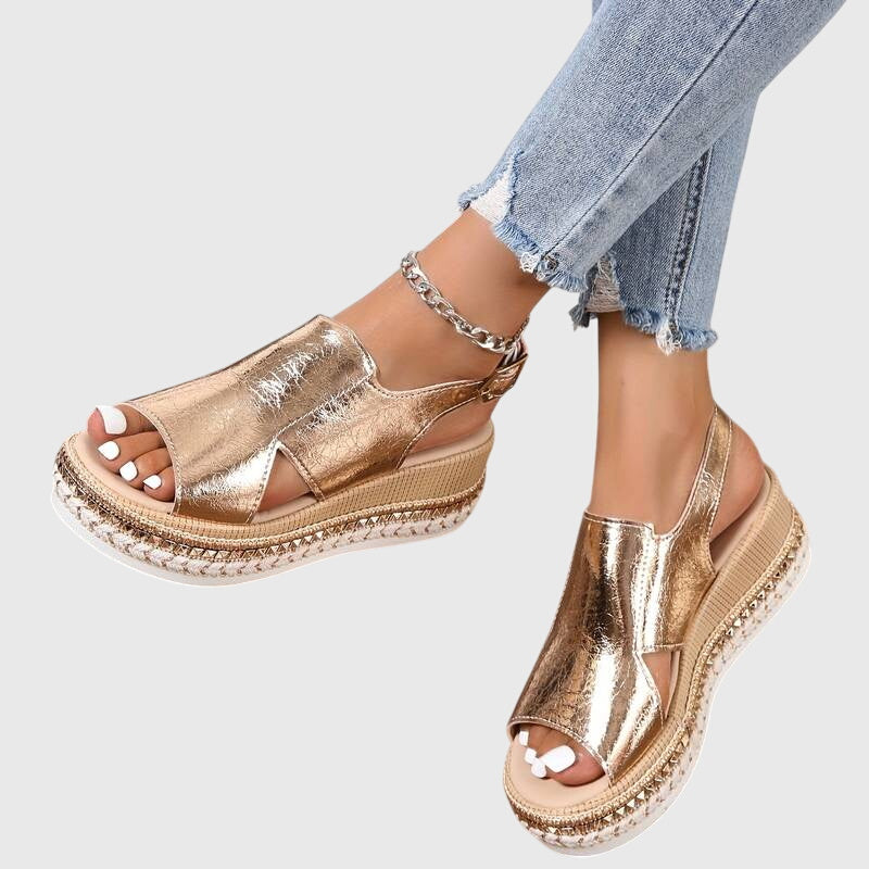 Metallic gold platform sandals with a detailed sole and cushioned footbed