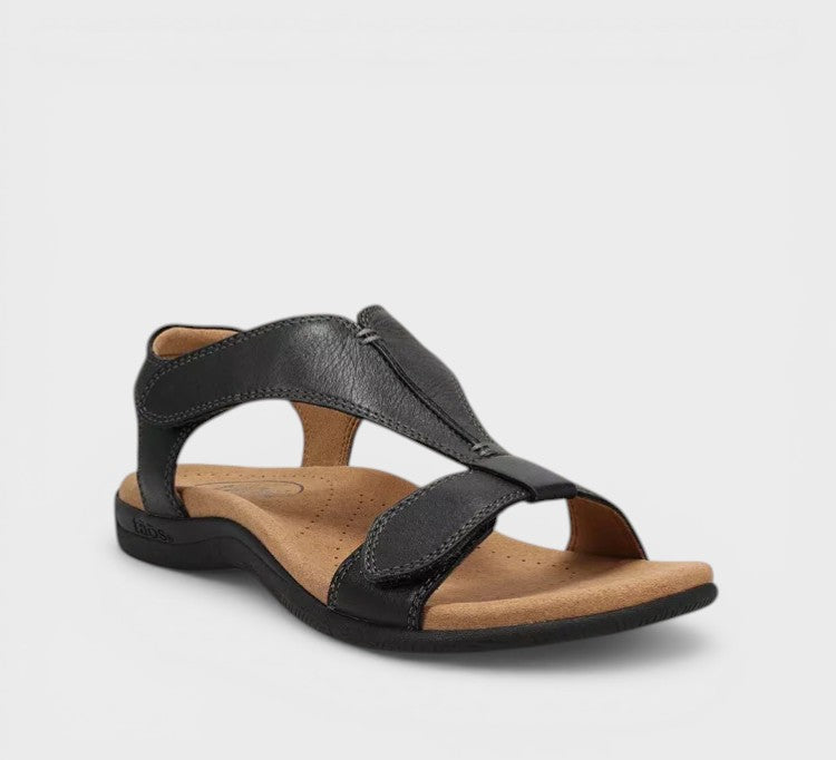 Elegant flat T-bar sandals in black and beige with a classic, refined strap design