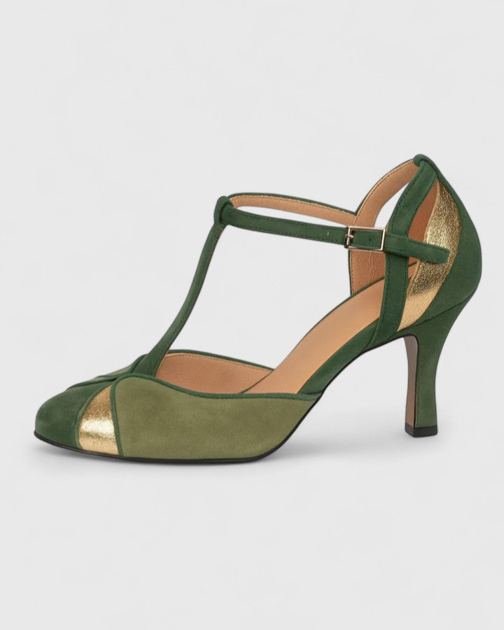 A woman wearing green open ankle-strap heels, stepping out in a bright, elegant look.