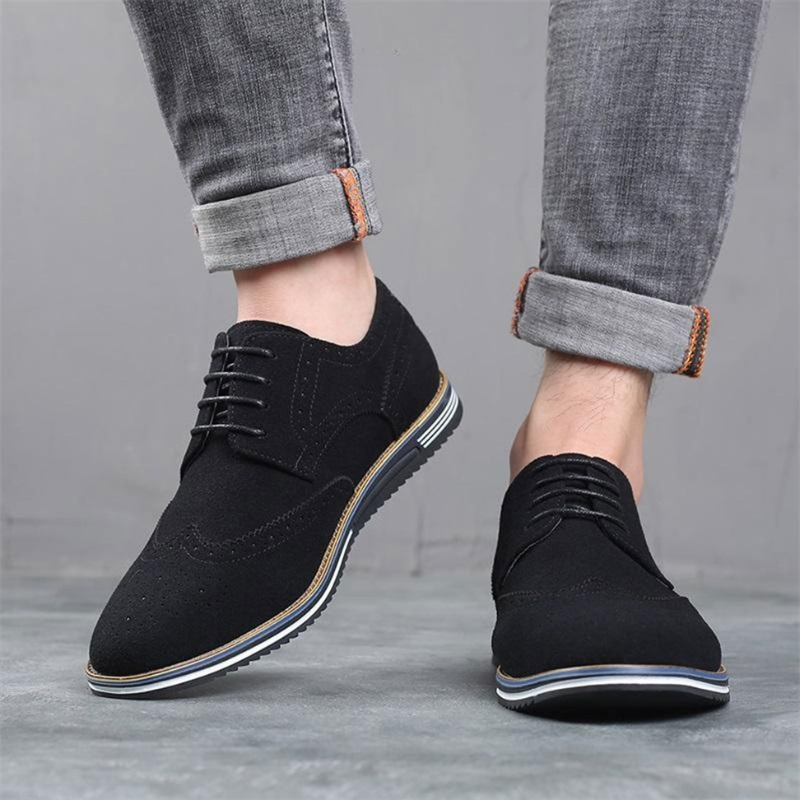 Men's black luxury dress shoes with a sleek pointed silhouette and polished smooth upper