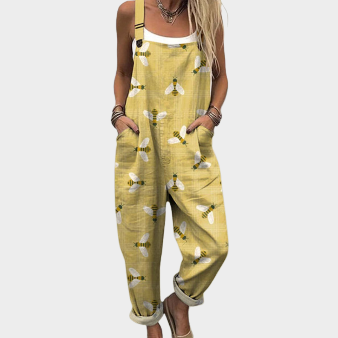 Woman wearing warm mustard dungarees printed with delicate white dragonflies
