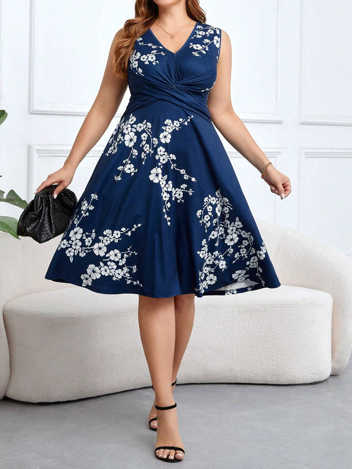 A woman wearing a sleeveless navy wrap dress with white floral print, the skirt flowing as she moves.