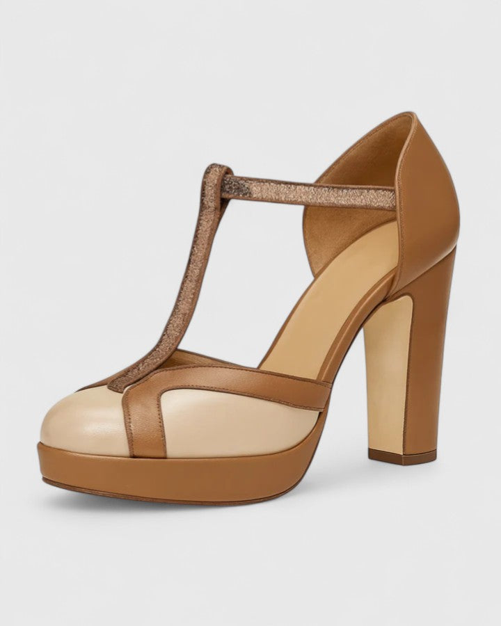 A woman wearing brown T-strap block heels, standing elegantly in a smart-casual outfit.