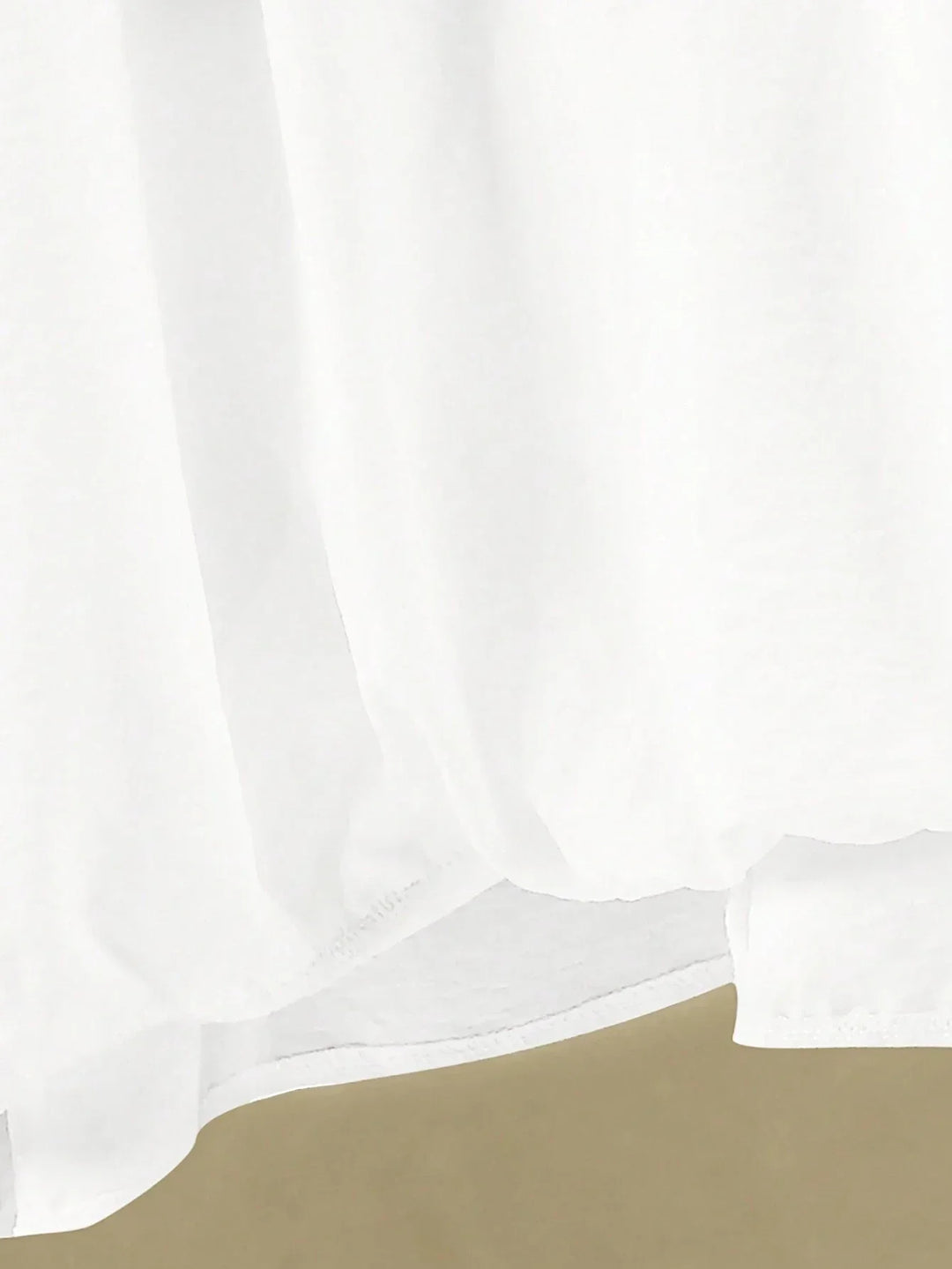 A woman wearing a flowing V-neck knot-detail top with matching flared trousers.