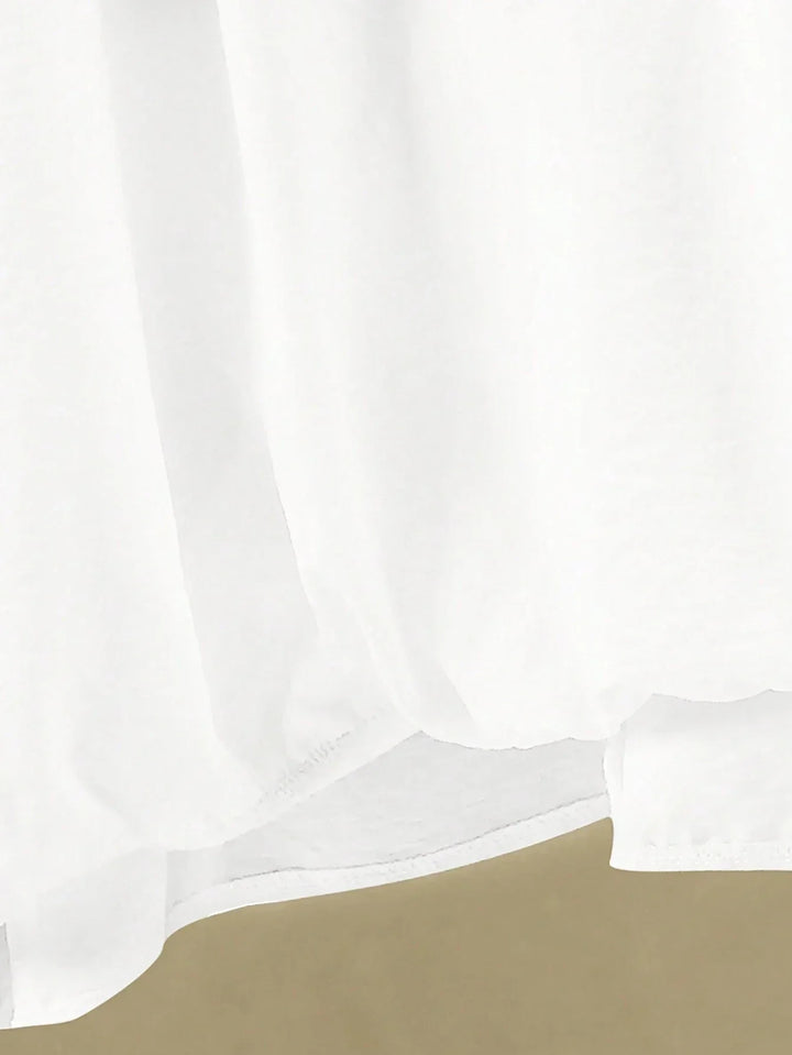 A woman wearing a flowing V-neck knot-detail top with matching flared trousers.