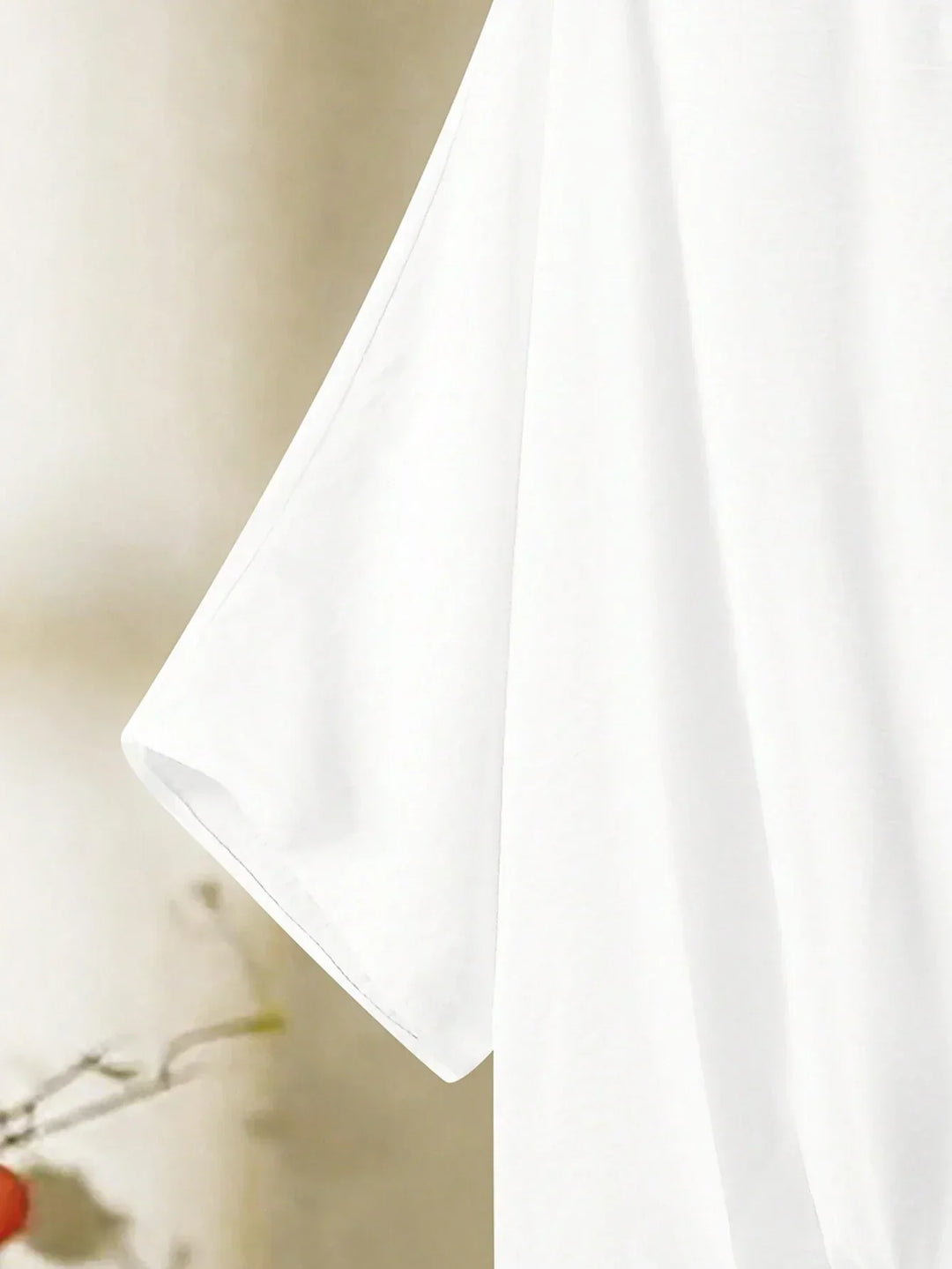 A woman wearing a flowing V-neck knot-detail top with matching flared trousers.