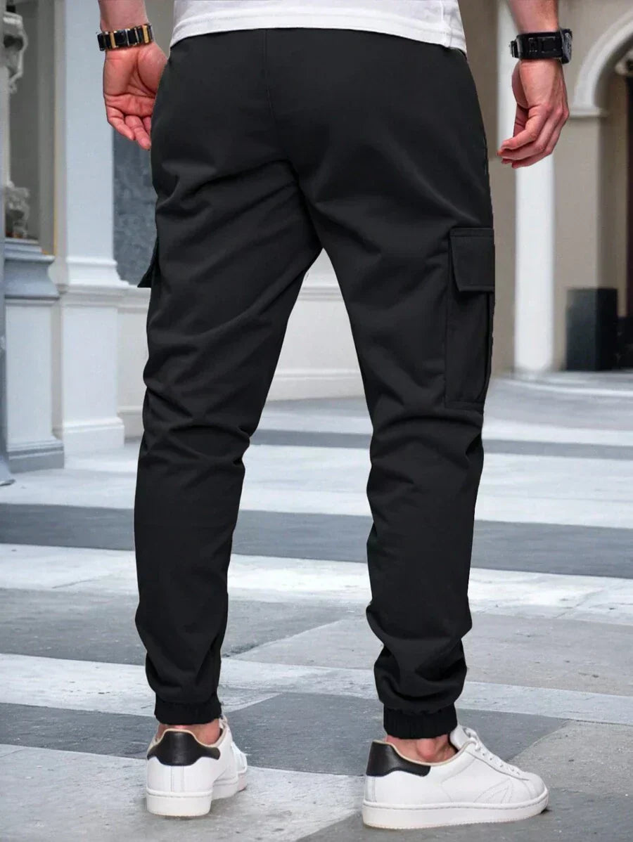 Men's modern urban cargo trousers in beige with cargo pockets and elasticated ankle cuffs
