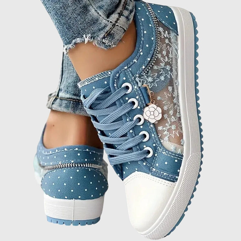 A woman walking comfortably in blue cushioned orthopaedic trainers
