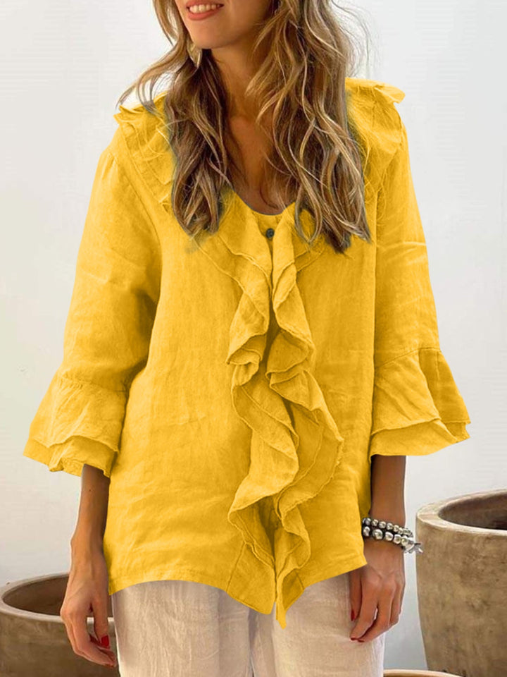 Blue floaty blouse with wide frill sleeves and a relaxed, feminine silhouette