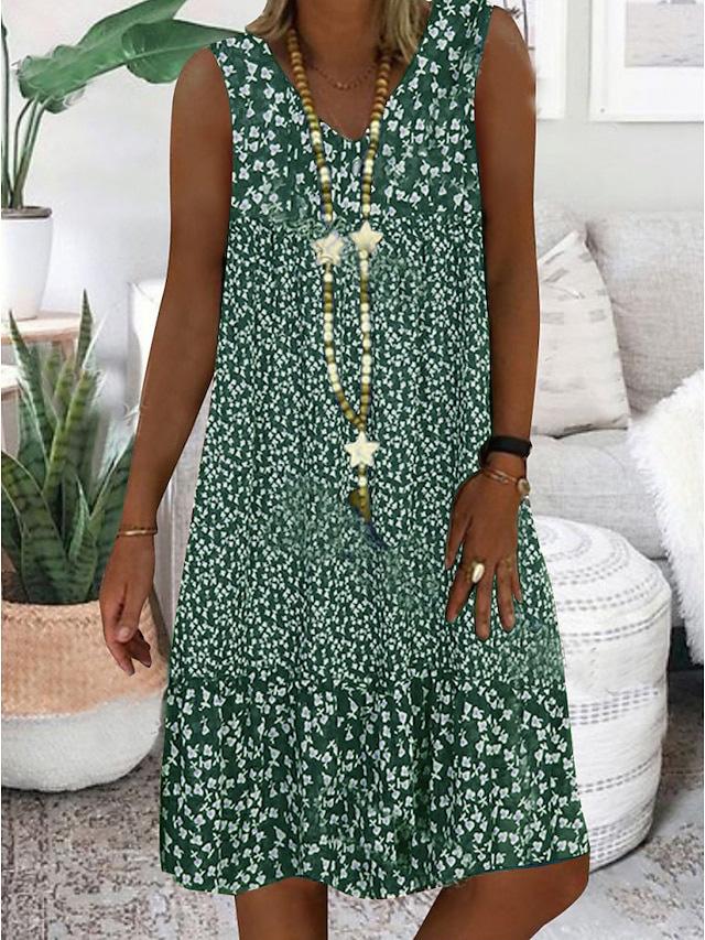 A woman wearing the Geraldine sleeveless V-neck floral dress on a sunny day outdoors.