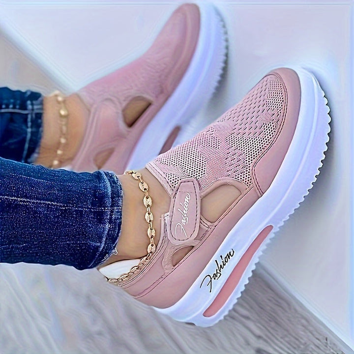 A woman slipping on breathable, cushioned slip-on trainers with trousers