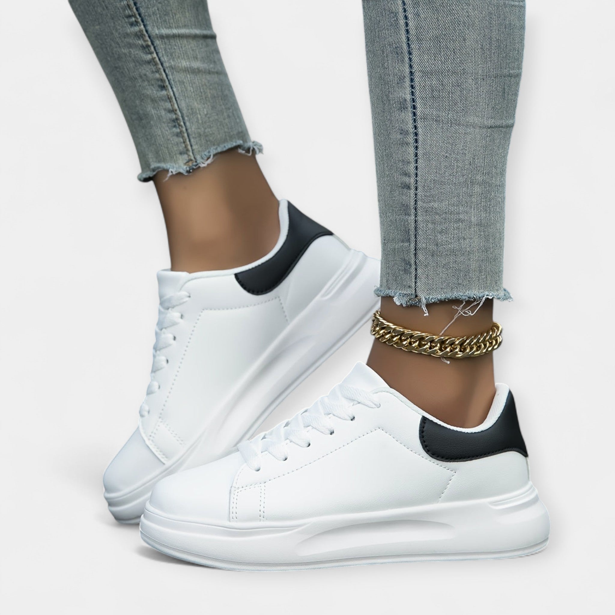 Women's classic white trainers with a clean minimal design and cushioned support sole