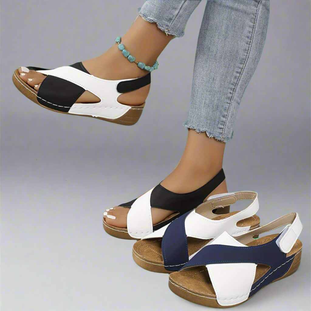 A woman walking outdoors in modern colourblock orthopaedic sandals with adjustable straps.