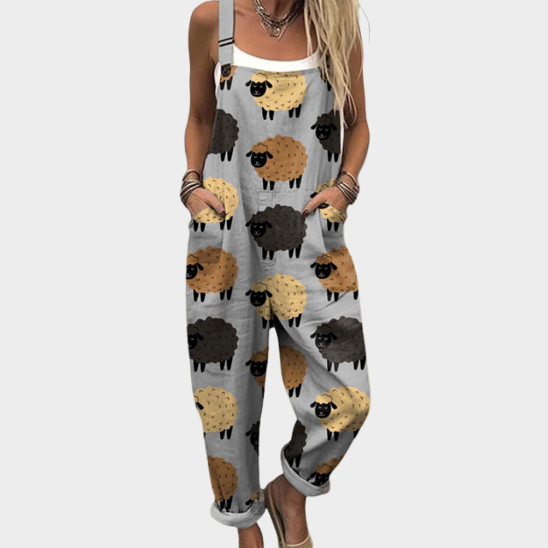 Woman wearing soft grey dungarees printed with cheerful little sheep in black, brown and cream
