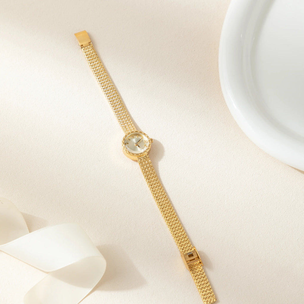 Women's minimalist gold watch with a simple round face and clean gold-tone finish