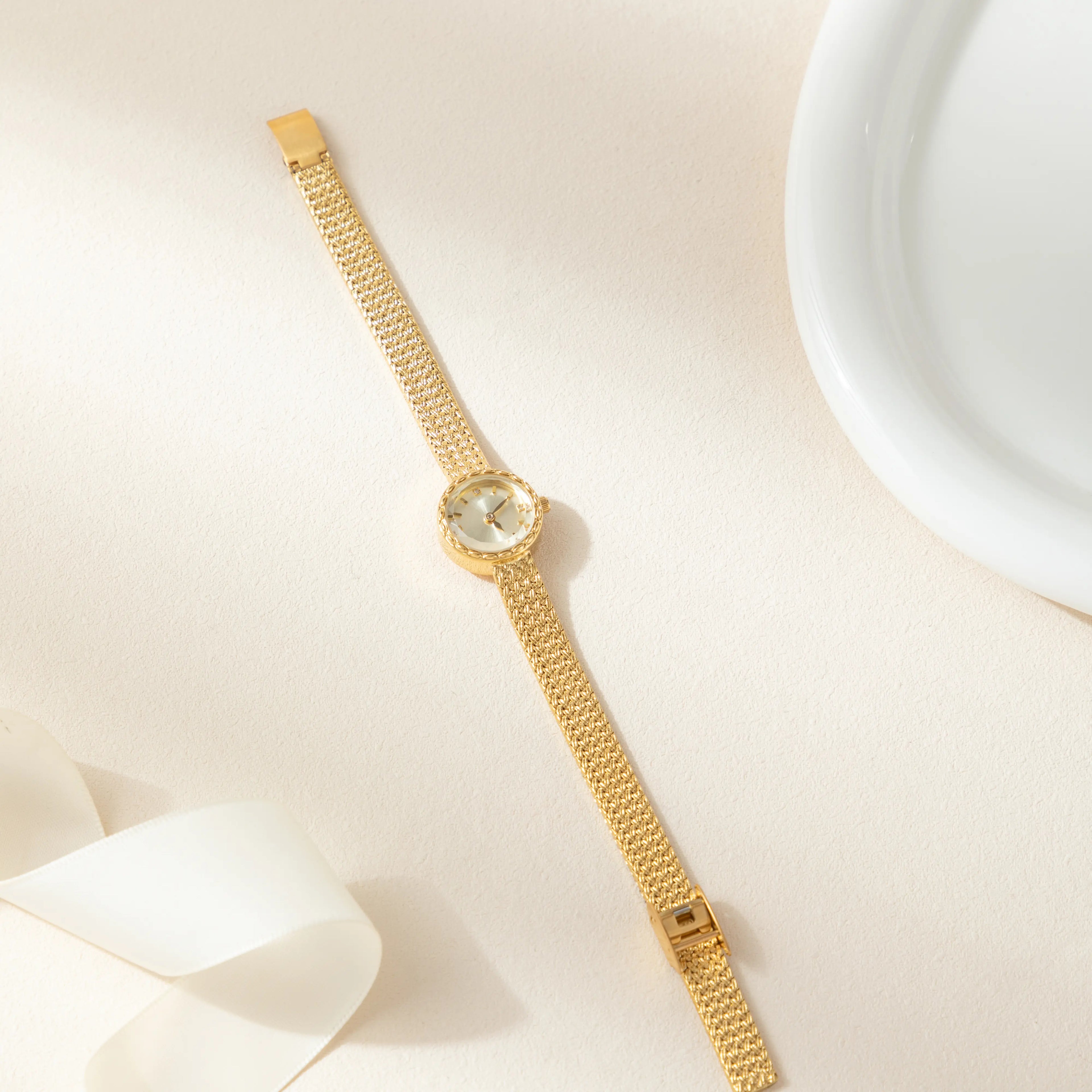 Women's minimalist gold watch with a simple round face and clean gold-tone finish