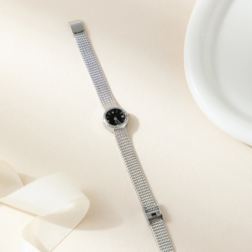 Women's minimalist gold watch with a simple round face and clean gold-tone finish