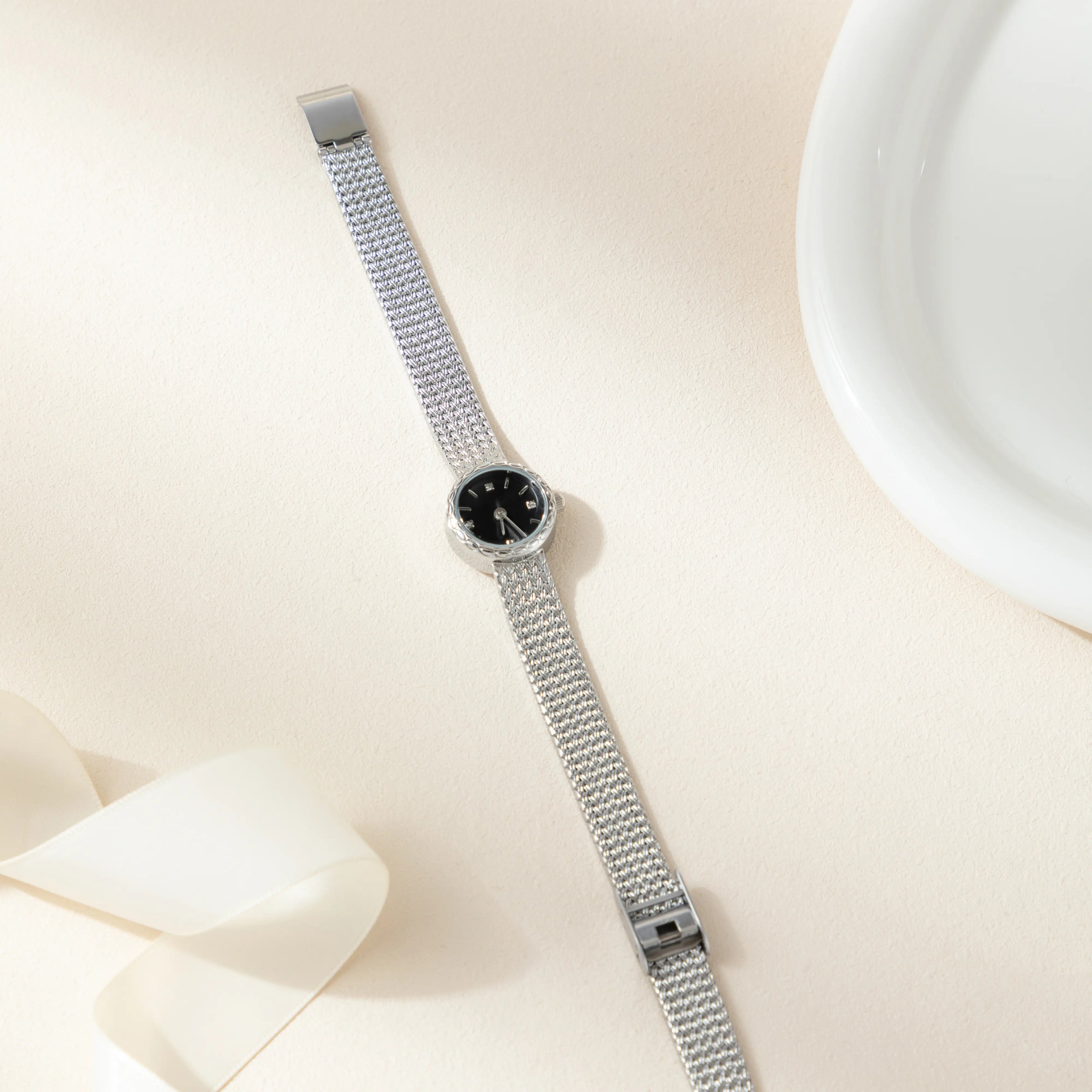 Women's minimalist gold watch with a simple round face and clean gold-tone finish