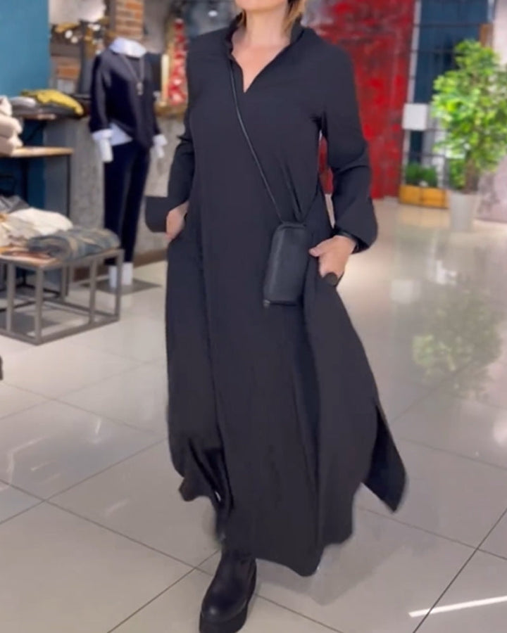 Woman wearing the Sarah relaxed maxi dress with revere collar, standing by a doorway.