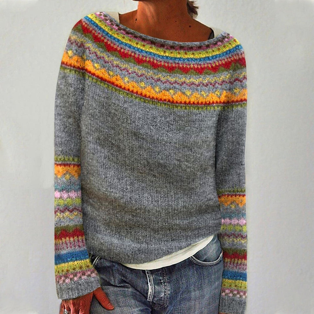 A woman wearing a retro jumper with a colourful Nordic pattern, cosy for autumn.