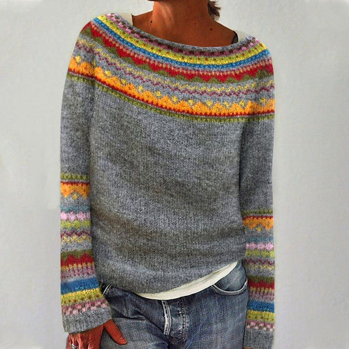 A woman wearing a retro jumper with a colourful Nordic pattern, cosy for autumn.