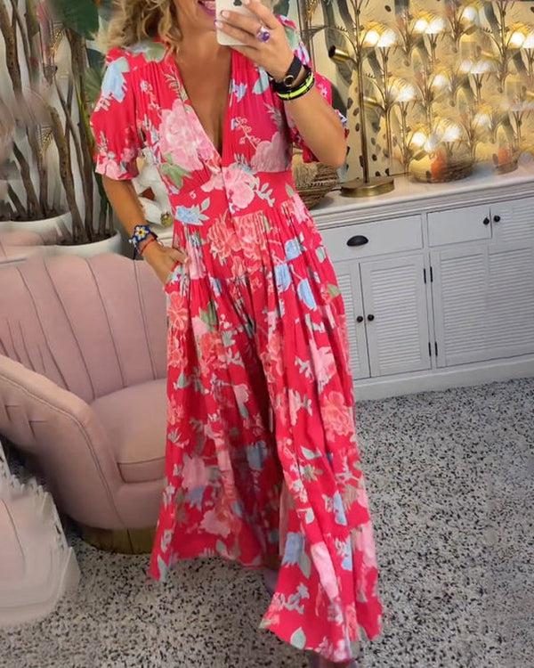 A woman wearing the Josephine bold floral maxi dress with a flowing full-length skirt at a garden gathering.