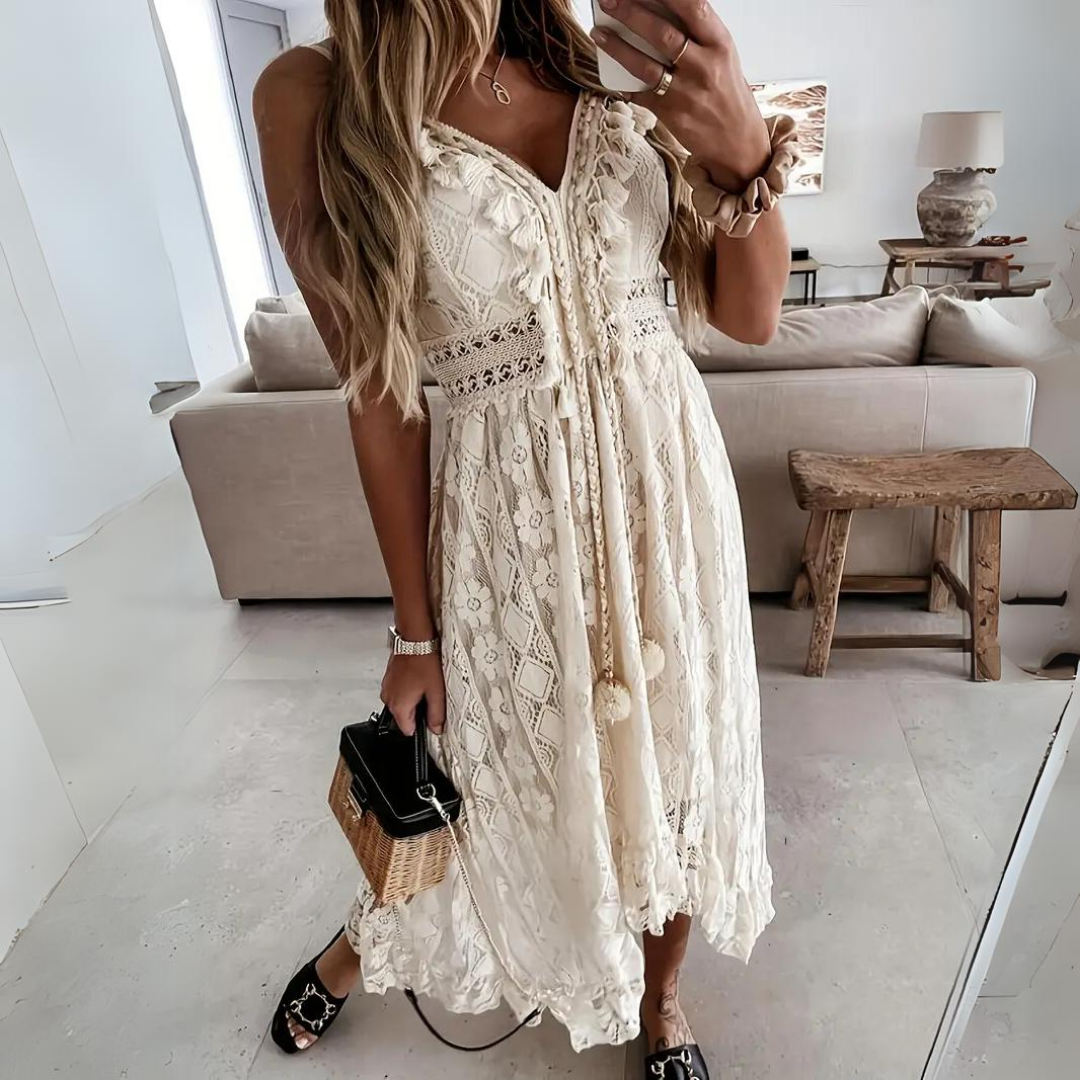 Woman wearing the Alice™ elegant boho midi dress with intricate detailing and a V-neckline at a summer garden party.