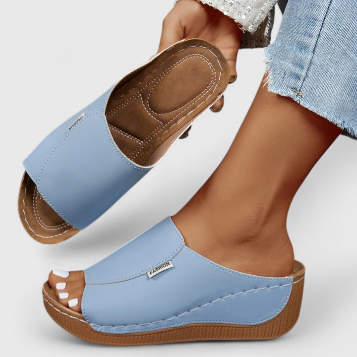 A woman in tan lightweight sandals stepping out gracefully, feet cushioned and supported.