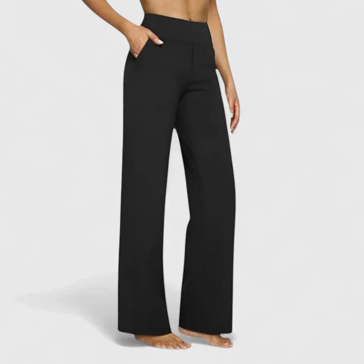 A woman in tailored trousers styled with a simple top for an elegant, comfortable everyday look.
