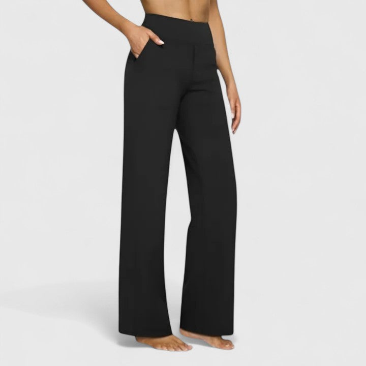 Woman wearing pull-on trousers with a soft blouse, relaxed and comfortable at home.