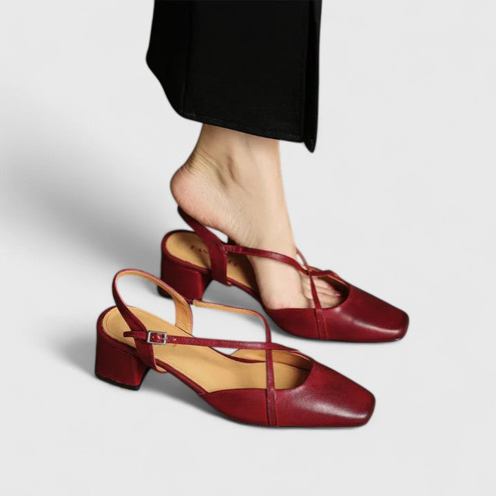 A woman wearing beige chic block heel sandals with an adjustable strap at an evening event.