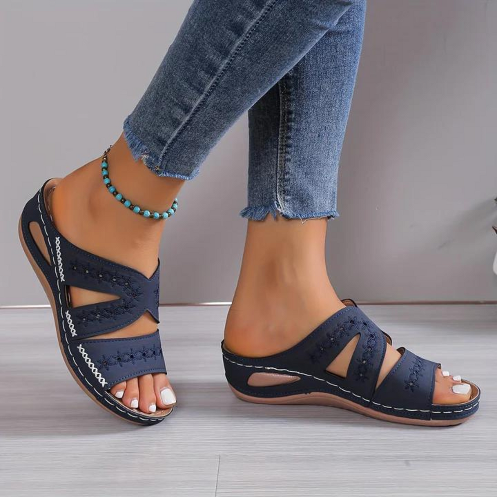 Women's crossover backless sandals with a cushioned footbed, shown in multiple summer colours