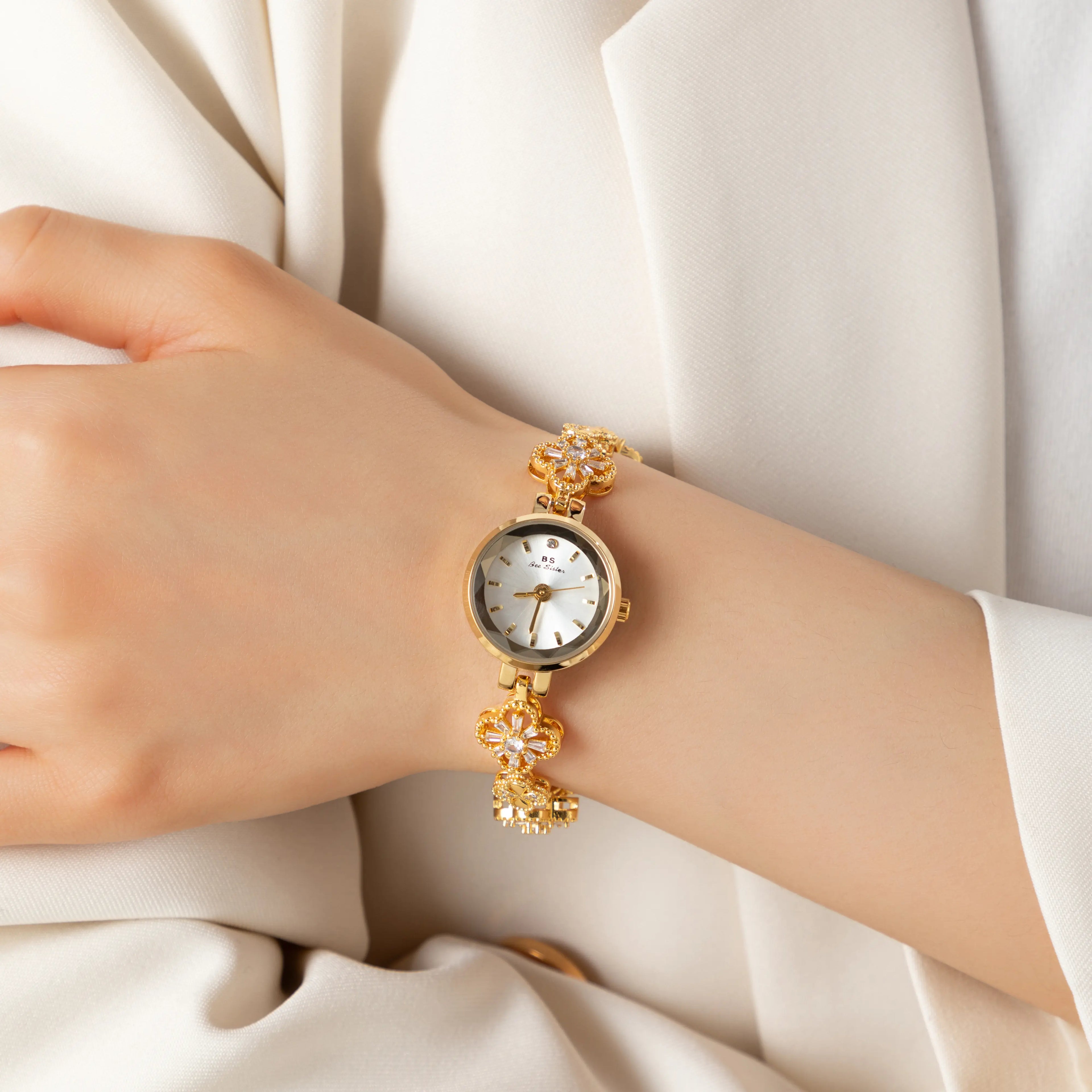 Women's gold-finish watch with rounded design and light-catching detailed face
