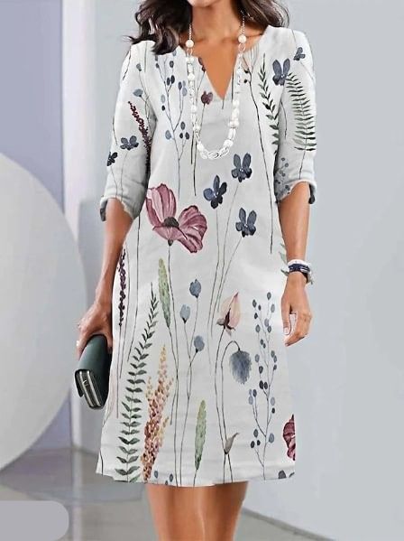 Woman wearing the Kathleen floral A-line dress in ivory, dressed for a daytime lunch.