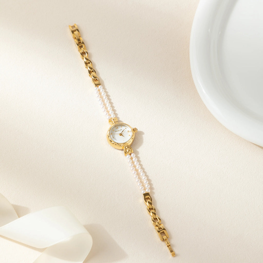 Women's gold watch with elegant twisted chain bracelet strap and a refined dial