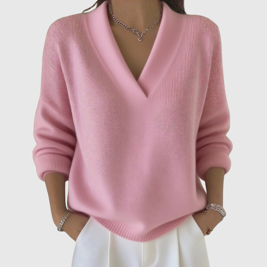 A woman wearing a soft draped V-neck jumper with jeans for an effortlessly elegant look.