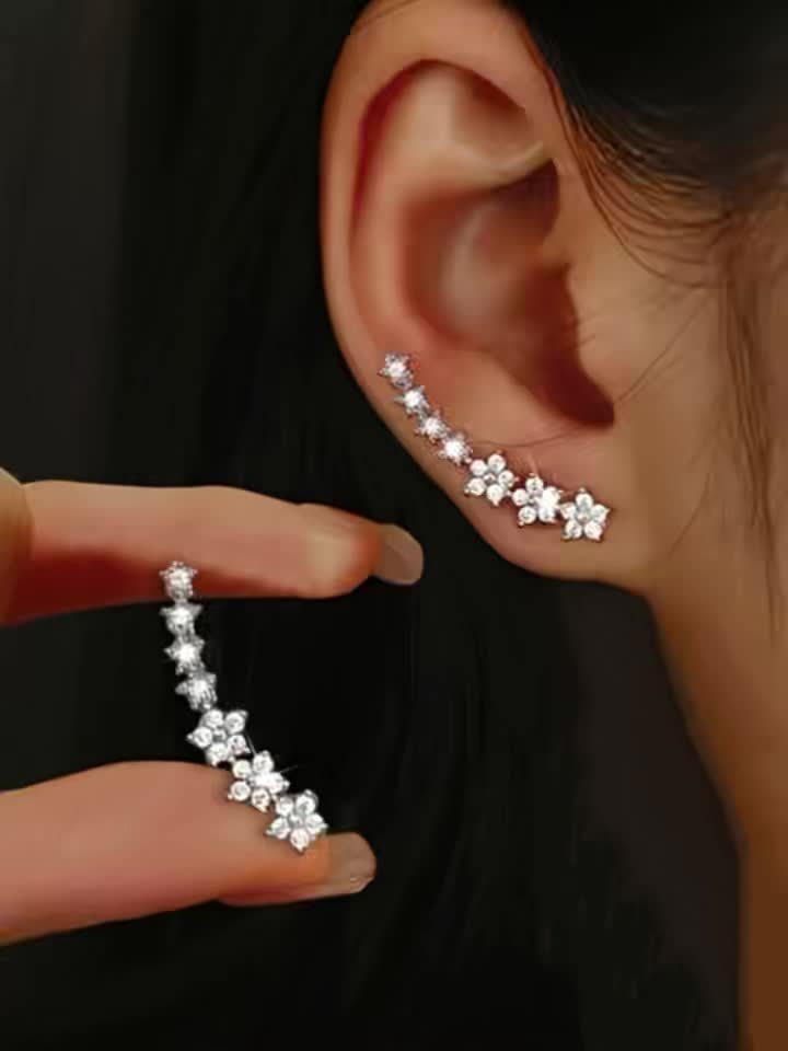 Rose gold floral crawler earrings with delicate sparkling floral motif following the curve of the ear