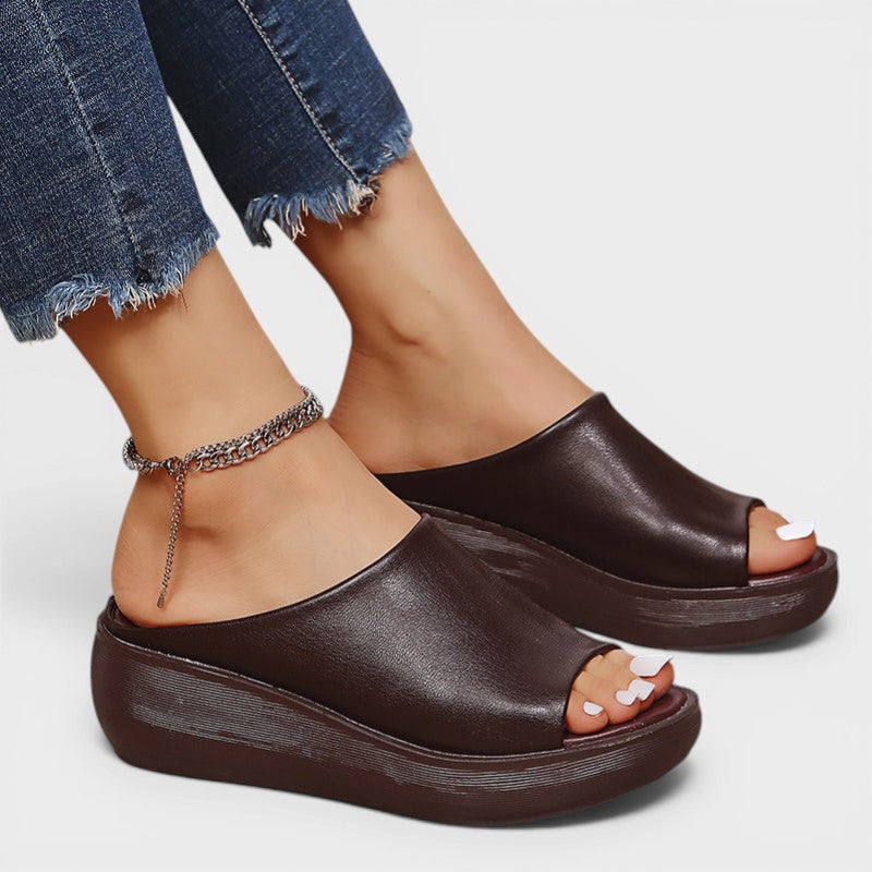 Open wedge mule sandals in white and brown with wide straps and a balanced wedge sole