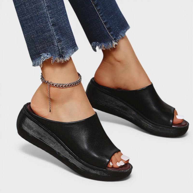 Open wedge mule sandals in white and brown with wide straps and a balanced wedge sole