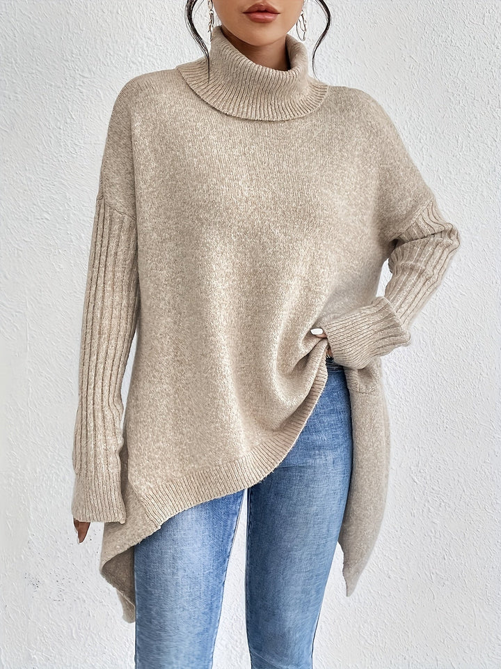A woman wearing a stand-collar jumper with a chic asymmetric drape, warm and polished.
