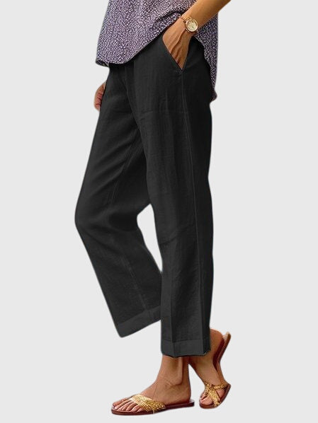 A woman wearing elegant tailored trousers with a flattering straight-leg cut and clean lines.