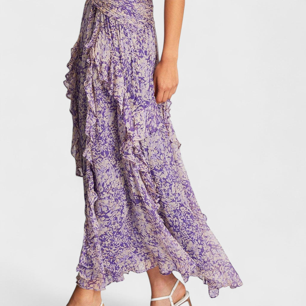 A purple floral fluid midi dress with a gently fitted bodice and flowing skirt