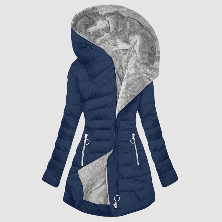 A woman wearing a cosy lined winter coat with a soft collar, looking warm and elegant.